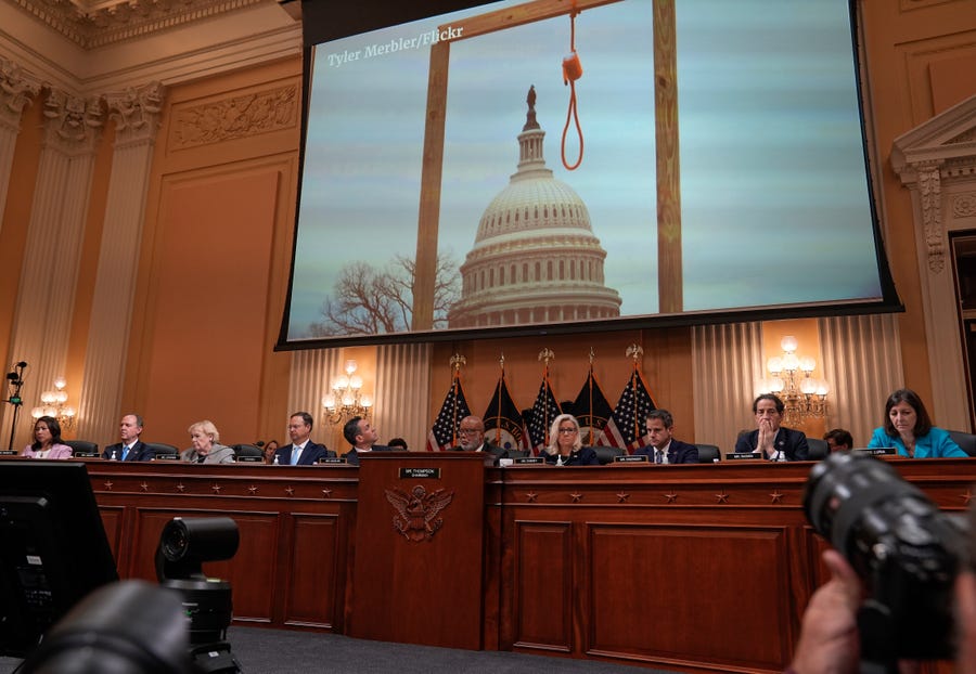 A video plays showing an image from Jan. 6, 2021 of a gallows in front of the U.S. Capitol on a large screen during the opening moments of the House select committee to investigate the Jan.6th attack on the Capitol on June 16, 2022.