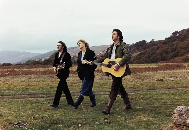 Denny Laine (left), Linda McCartney and Paul McCartney traverse the countryside for the "Mull of Kintyre" video.