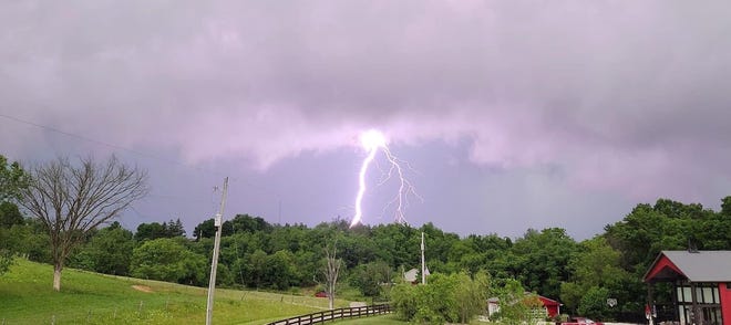 A powerful bolt of lightning illuminates the sky over Senecaville during Thursday evening storms.