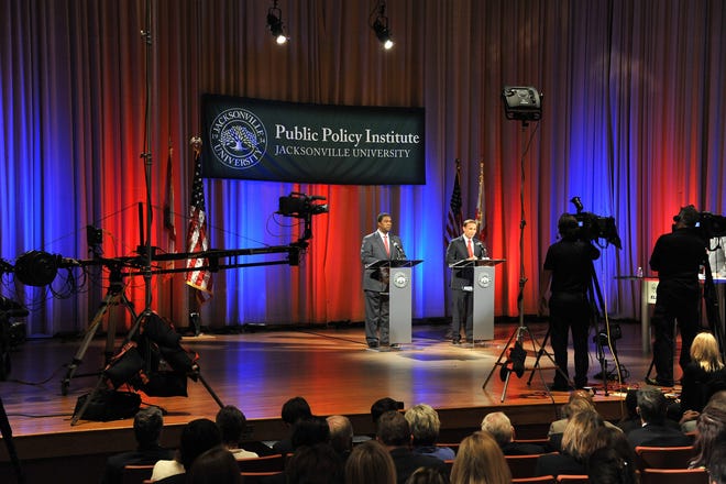 Former and current Jacksonville mayors Alvin Brown (left) and Lenny Curry  talk about gun violence during a 2015 candidate debate at Jacksonville University organized by the school's  Public Policy Institute. The institute has scheduled an Oct. 6 debate for candidates in Florida's governor's race.