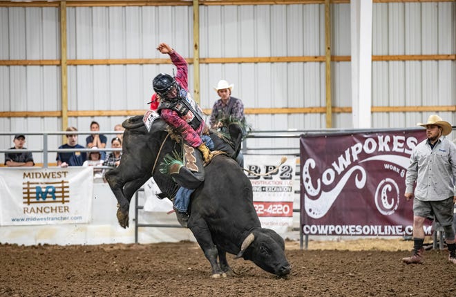 Edgewood's Cash Turner hangs on tight during bull riding competition at the 2022 Indiana High School Rodeo Association state championships in Nineveh.