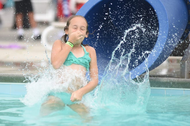 In this 2019 photo, a child with the YMCA summer camp program cool off at the Robert Strange Pool.
