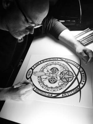 Henderson author and illustrator Hugh Alan Samples works on a drawing from one of his published works, "Wee William Witchling." His current project, titled "The Journal of Absolute Misery" can be found on the crowdfunding website Kickstarter.