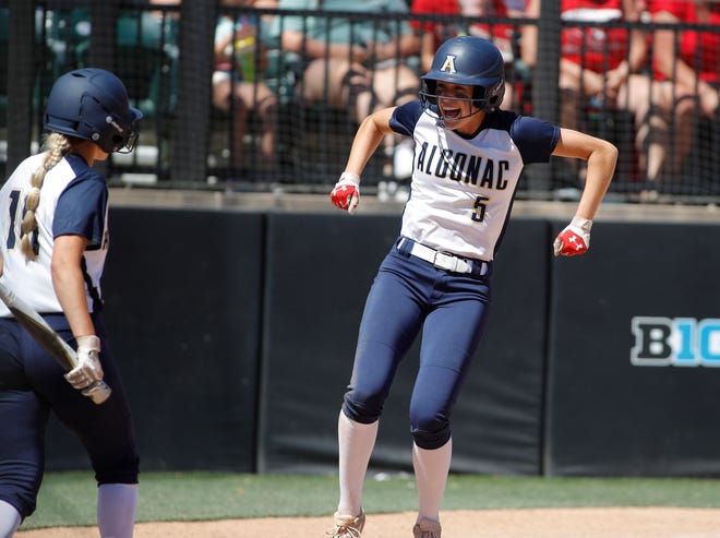 Algonac's Ella Stephenson (right) celebrates after scoring a run during a game last season. She finished with 17 home runs and 38 RBI in 2022.