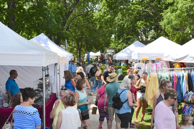 People browse the artisan tents at the annual Lemonade Concert and Art Fair.