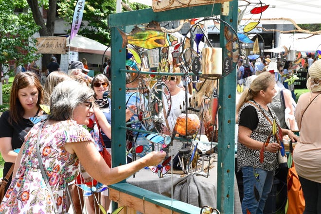 People browse the artwork for sale at the annual Lemonade Concert and Art Fair.