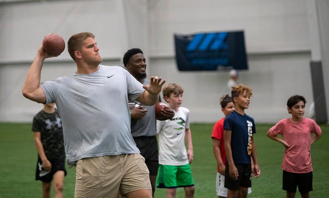 Brain O'Neill of the Minnesota Vikings throws passes at a free NFL clinic for youths at Chase Fieldhouse, Friday, June 17, 2022.