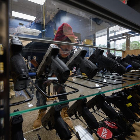 A customer browses guns for sale at RTD Arms & Spo