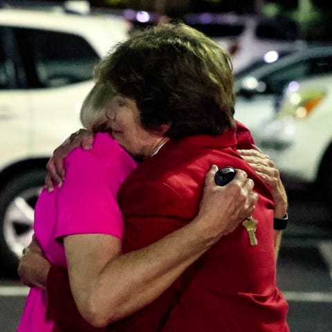 Church members console each other after a shooting