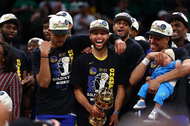 Jordan Poole #3, Stephen Curry #30 and Damion Lee #1 of the Golden State Warriors celebrate after defeating the Boston Celtics 103-90 in Game Six of the 2022 NBA Finals at TD Garden on June 16, 2022 in Boston, Massachusetts.