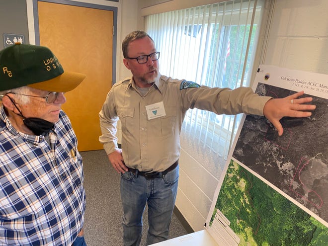 Jim Merzenich, owner of Oak Basin Tree Farm, looks over the map for the proposed habitat restoration area that sits next to his farm near Brownsville.