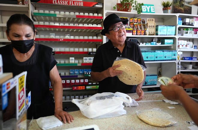 After 62 years the family is retiring from Bill's Market in Tempe. Mary and Bobby Figueroa help a customer on their penultimate day, June 17, 2022. The market is known for their chorizo.