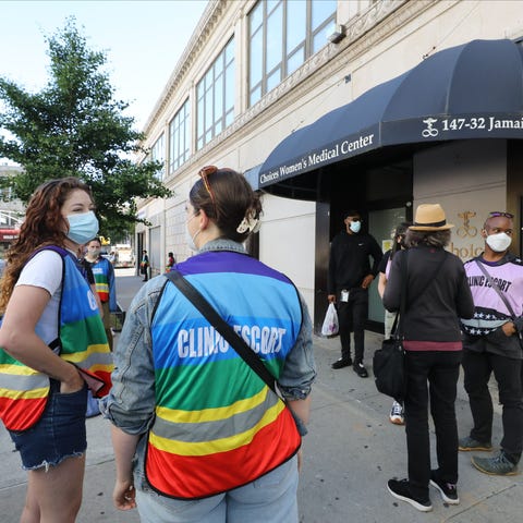 A group of volunteer clinic escorts (in multi colo
