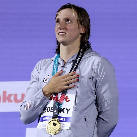 Gold medalist Katie Ledecky stands on the podium f