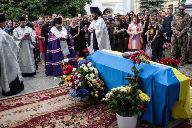 Priests pray during the memorial service for Roman Ratushny in St. Michaels Cathedral on June 18, 2022 in Kyiv, Ukraine. Mr Ratushny was killed in battle on June 9 near Izium, southeast of Kharkiv.