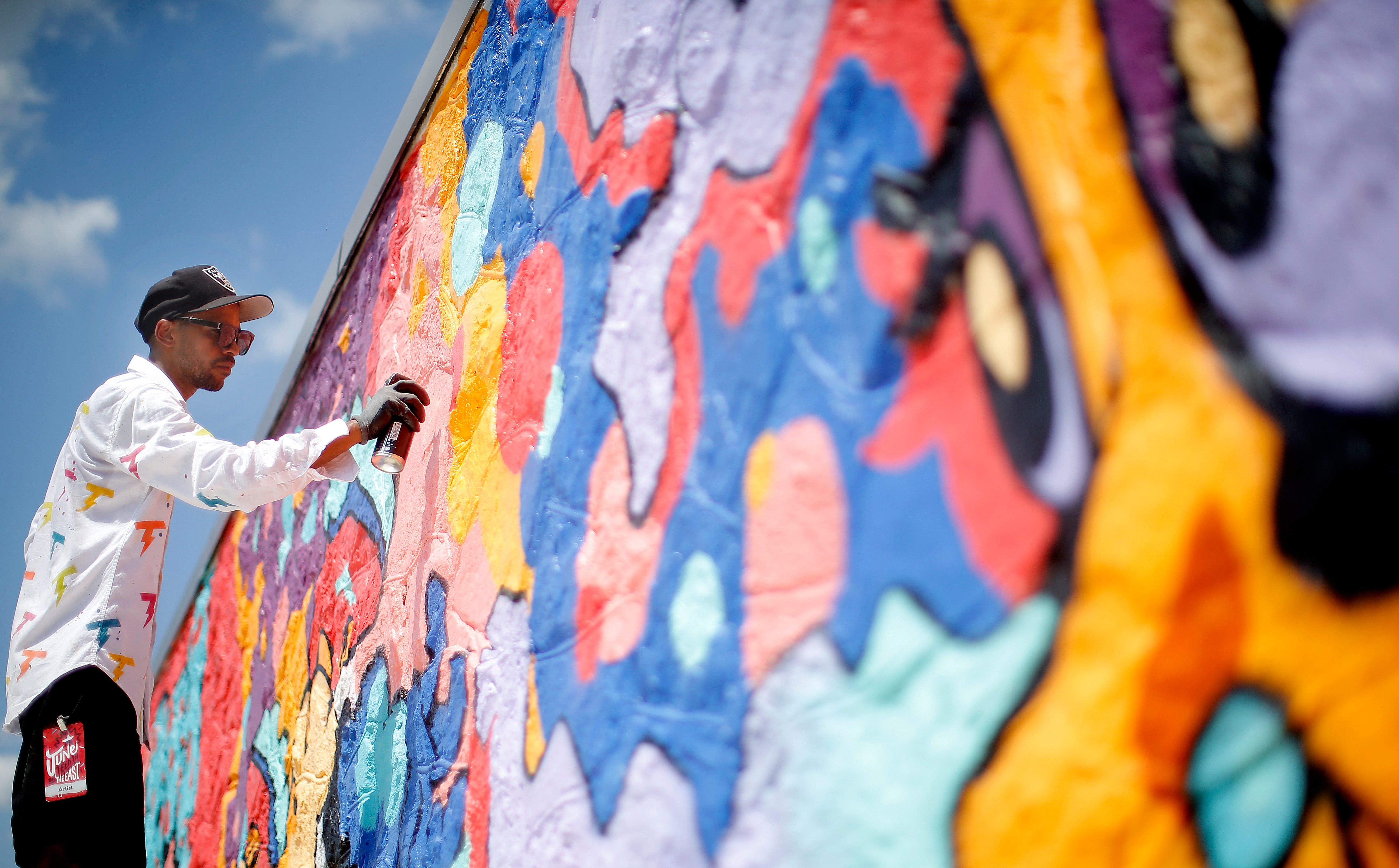 Tony Thunder works on a mural during Juneteenth on East in Oklahoma City, Saturday, June, 18, 2022. 