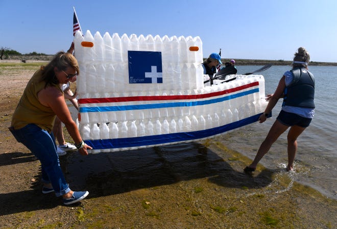 The team from My Emergency Room carries their entry, the Blood Vessel, into the waters of Lake Fort Phantom Hill Saturday. Global Samaritan Resources held its first Recycled Regatta, where sponsored competitors raced in craft made from recycled items.