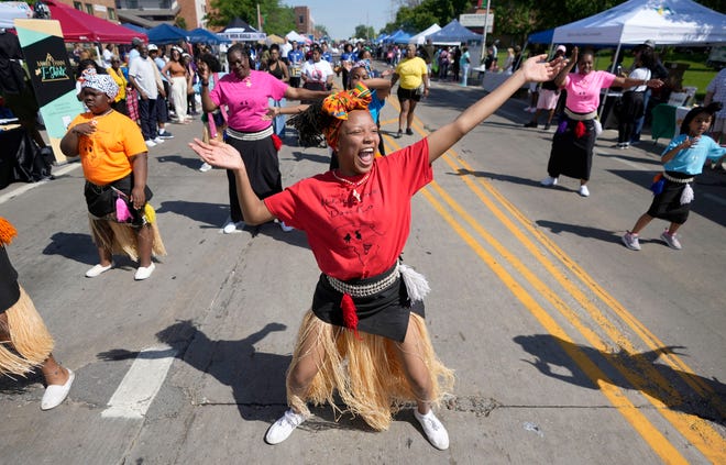 Adila Winston, center, and other members of the Nefertari African Dance Company perform in the Juneteenth Day parade as part of the Juneteenth Day celebration in Milwaukee on Sunday. This year marked the 51st anniversary of Milwaukee's Juneteenth Day gathering, one of the oldest in the country.