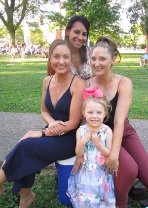 Mariah Hutchinson, left, and Ashley Moore, at right, teamed up as emcees for the Rotary-sponsored Geneseo Music Festival Queen Pageant held Friday, June 17, in City Park. With the emcees are Heather DeBrock, in back, pageant committee member; and Tille Moore, who wanted to help Mom at the pageant