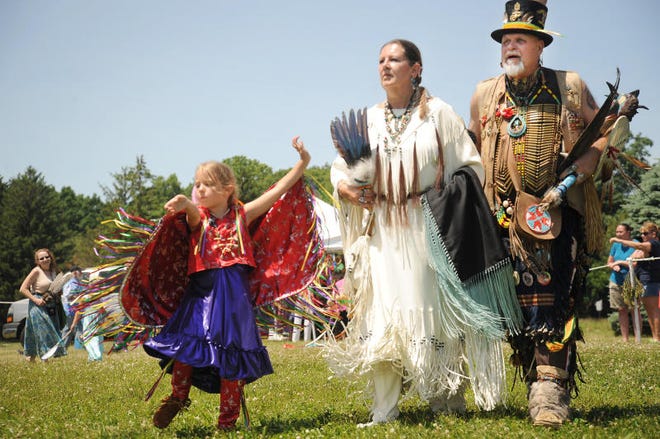 Ayita Hutchison, 6, of Etowah, TN, dances with her grandparents Nacombius Nacadeanna of Muskegon and Salamander Bearwalker of Odanak, Canada, the lead female and male dancers, during the Native American Pow Wow in 2014. Monroe News