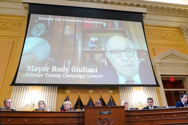 FILE - A video deposition of former Trump campaign attorney and former New York Mayor Rudolph Giuliani plays as the House select committee investigating the Jan. 6 attack on the U.S. Capitol continues to reveal its findings of a year-long investigation, at the Capitol in Washington, Monday, June 13, 2022. (AP Photo/Susan Walsh, File)