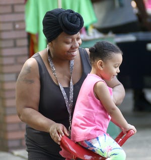 Courtney Weatherspoon, left, pushes her daughter Amelia Dunn, 3, on the teeter-totter at the Alliance 2022 Juneteenth Community Cookout celebration on Sunday, June 19, 2022, at Thompson-Snodgrass Park in Alliance.