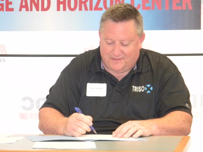 TRISO-X President Peter Pappano signs documents to acquire land for a new nuclear fuel facility in Oak Ridge.