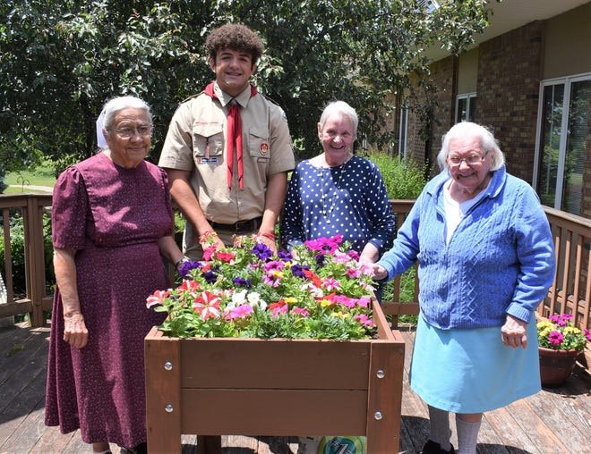For his Eagle Scout project, Trey Charlton of Dover built five planter boxes for Walnut Hills Retirement Community in Walnut Creek. He is pictured here at one of them with assisted living residents Dorothy Yutzy, Jackie Forrest and Iva Swartzentruber.