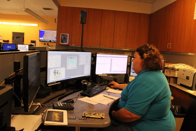 Erin Allwardt fields calls inside the Calhoun County Consolidated Dispatch Center Friday, June 17.