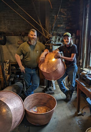 James Patrick, left, and Rex Bitner with some of their copper kettles.