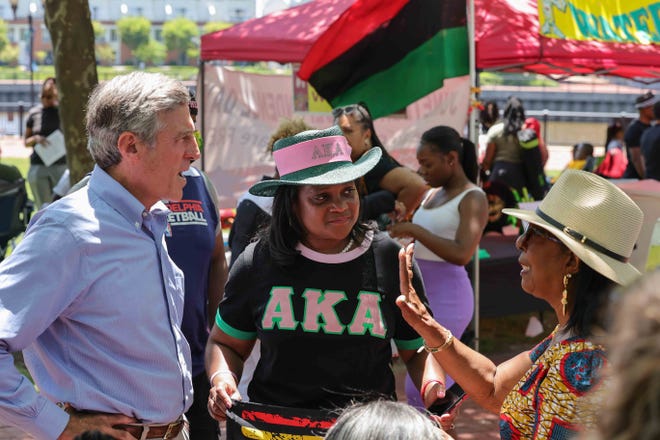 Delaware Gov. John Carney, left, state Rep. Sherry Dorsey Walker, center, and Juneteenth Pageant director Sandy Clark speak during the annual Juneteenth Parade on Monday, June 20, 2022, in Wilmington.