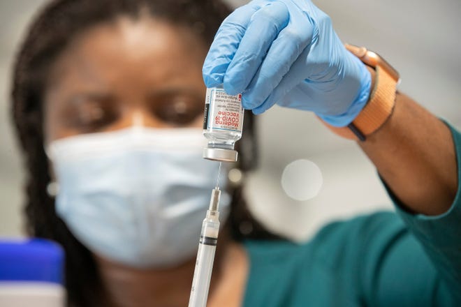 A nurse prepares Moderna COVID-19 vaccinations at an Austin Public Health vaccine clinic last year. As of June 29, Massachusetts hospitals were treating 491 patients with COVID-19. Forty-eight of those patients were in the ICU and 15 were intubated.