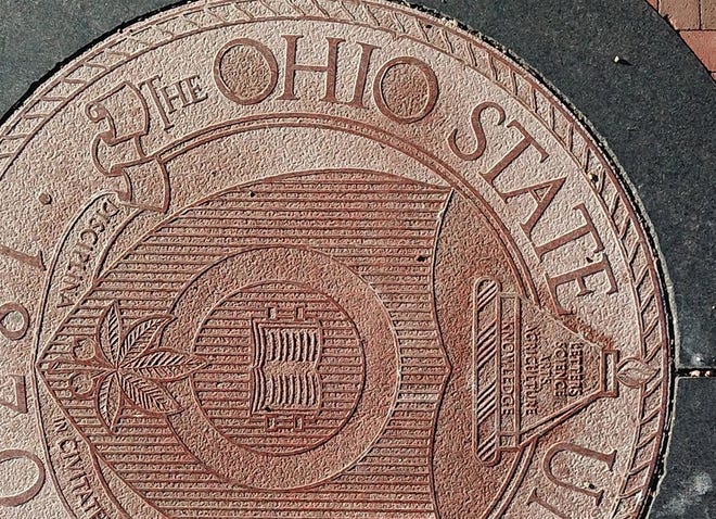 Ohio State University regularly uses the definitive article "The" in front of its name, as seen here in the university seal embedded in the pavement at the east entrance to the Oval on the main campus in Columbus.
