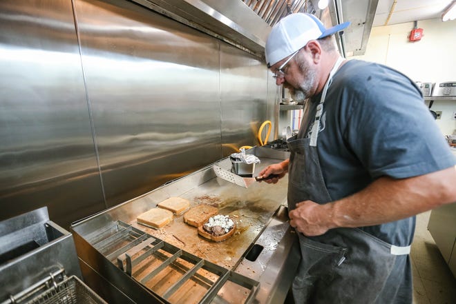 Curt Breuklander, a partner at Grill on the Hill, makes a Monte Cristo Blues sandwich on June 22 in Oklahoma City.