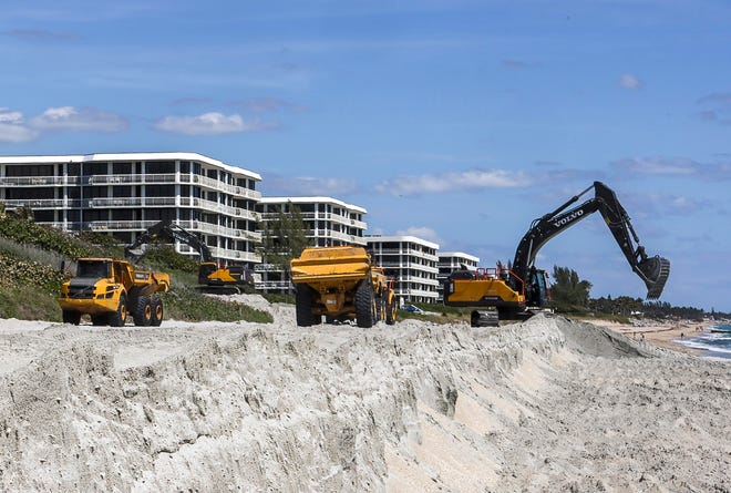 Trucks are loaded with sand at Phipps Ocean Park as the beach renourishment project continues and makes its way south, Tuesday, April 6, 2021. DAMON HIGGINS / PALM BEACH DAILY NEWS