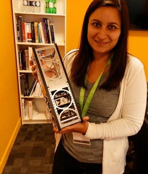 Sara Rivero-Calle holds a model of the Seahawk-1 satellite.
