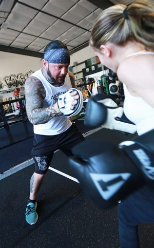 Trainer Chad Leoncello works with student Madison Concannon at Leoncello Boxing in Raynham on Tuesday, June 21, 2022. 