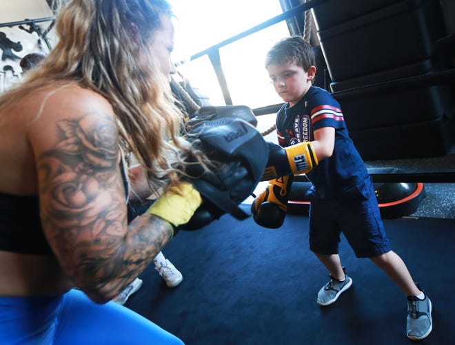 Trainer Brieanna Resendes works with Rocco Boccabella, 5, at Leoncello Boxing in Raynham on Tuesday, June 21, 2022.