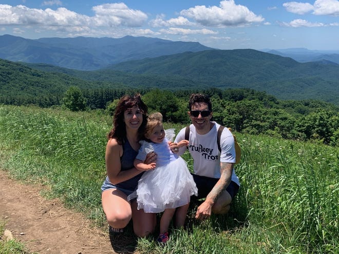 Knoxville, Tenn. residents Jason and Katie Wise pose atop Max Patch June 18, 2022, with their daughter, Sully.