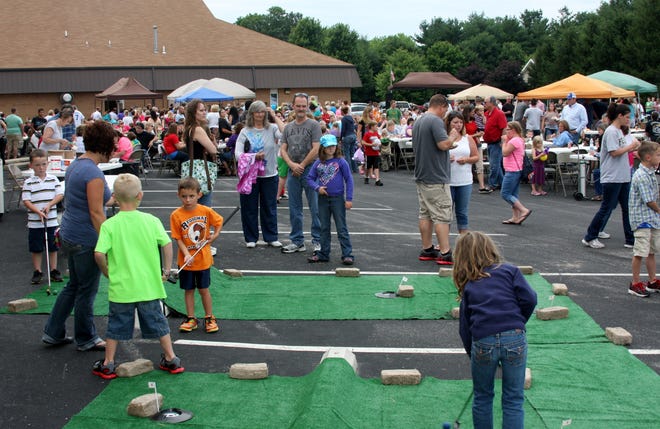 Children play mini golf at a previous Freedom Celebration event.