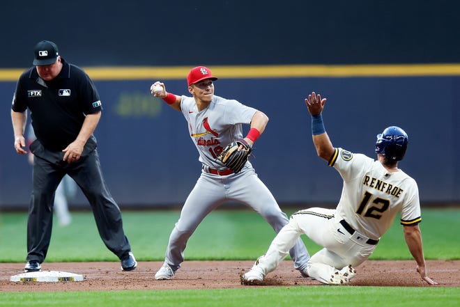 Tommy Edman of the St. Louis Cardinals turns a double play as the Brewers' Hunter Renfroe slides into second base Tuesday night.