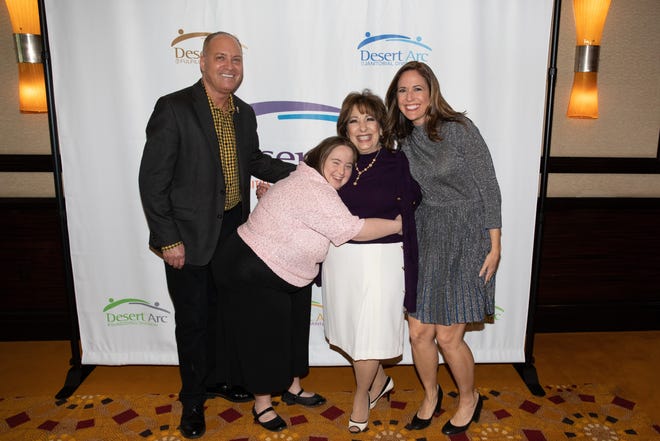 Glenn Miller, vice chair of Desert Arc’s board of directors, poses with Victoria, Desert Arc Client of the Year awardee; Renee Griffin, Desert Arc Volunteer of the Year awardee; and Brooke Beare, event emcee.