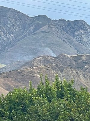 Smoke rises from a brush fire that broke out Wednesday morning near Boosey Road in Santa Paula.
