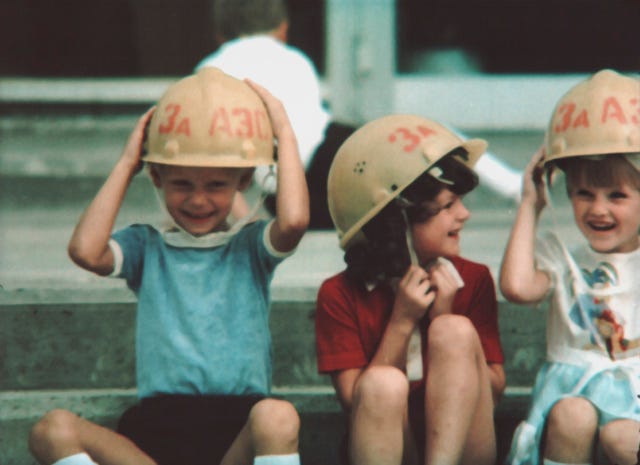 Children play with hard hats in the neighborhoods around Chernobyl.