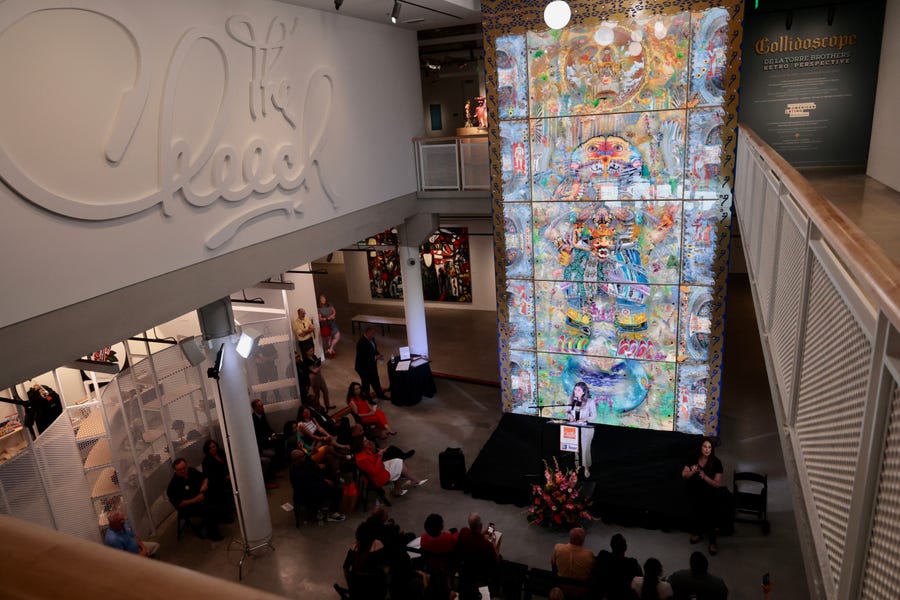 Executive Director Drew Oberjuerge speaks during the Civic Dedication of The Cheech Marin Center for Chicano Art & Culture of the Riverside Art Museum, June 16, 2022. Artwork depicting a goddess rising from the earth by brothers Einar and Jamex de la Torre stretches 26 feet from the ground floor to the second-level balcony.