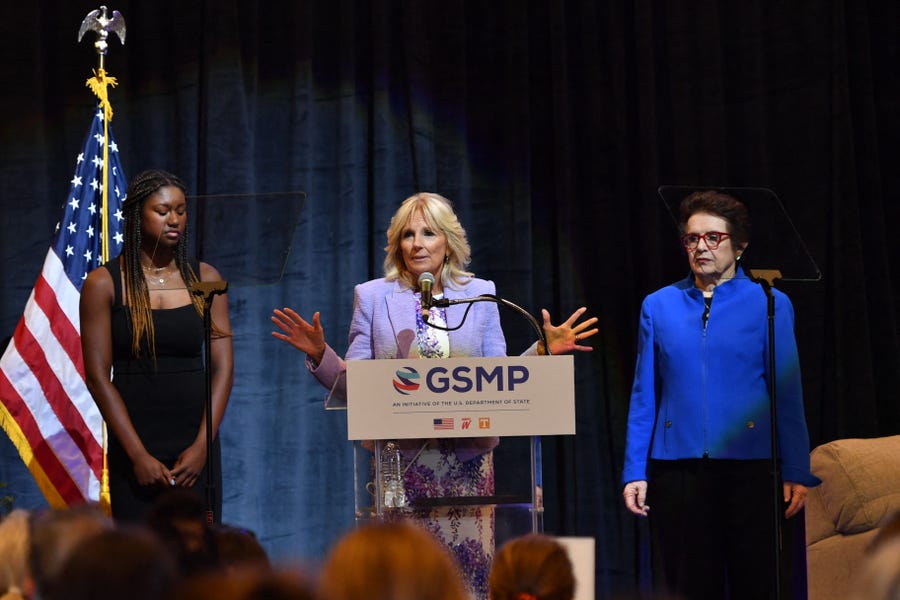 Tennis legend Billie Jean King (R) and high school track athlete Maya Mosley (L) listen to first lady Jill Biden  speak during an event to mark the 50th anniversary of Title IX and the 10th anniversary of the State Department-espnW Global Sports Mentoring Program, at Capitol One Arena in Washington, DC, on June 22, 2022. Title IX is the 1972 federal civil rights law that prohibited sex-based discrimination in educational programs that receive federal financial assistance.