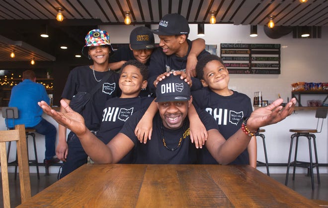 Crafted Culture founder Anthony “Sizzle” Perry (foreground) at the brewery's former taproom in Gahanna with his kids, from left: Robyn, Thomas, Isaac, Joe and Thomas’ twin brother Daniel