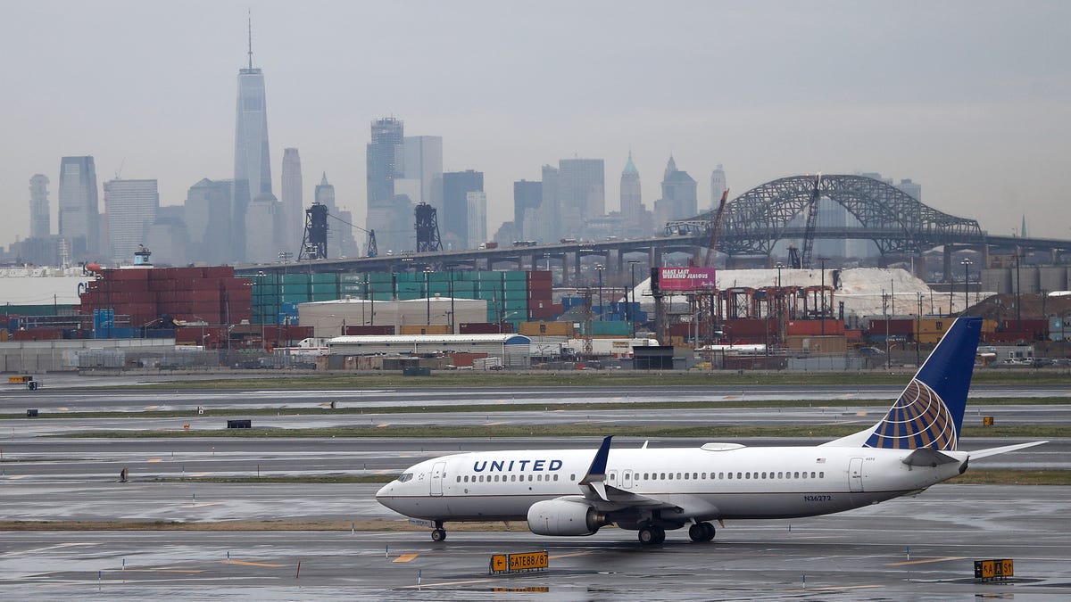 The New York City skyline gives backdrop to a United Airlines airplane taxing at Newark Liberty International Airport, Wednesday, April 12, 2017, in Newark, N.J. (AP Photo/Julio Cortez) ORG XMIT: NJJC10