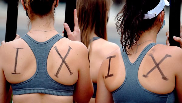 Members of the UConn women's rowing team rally abo