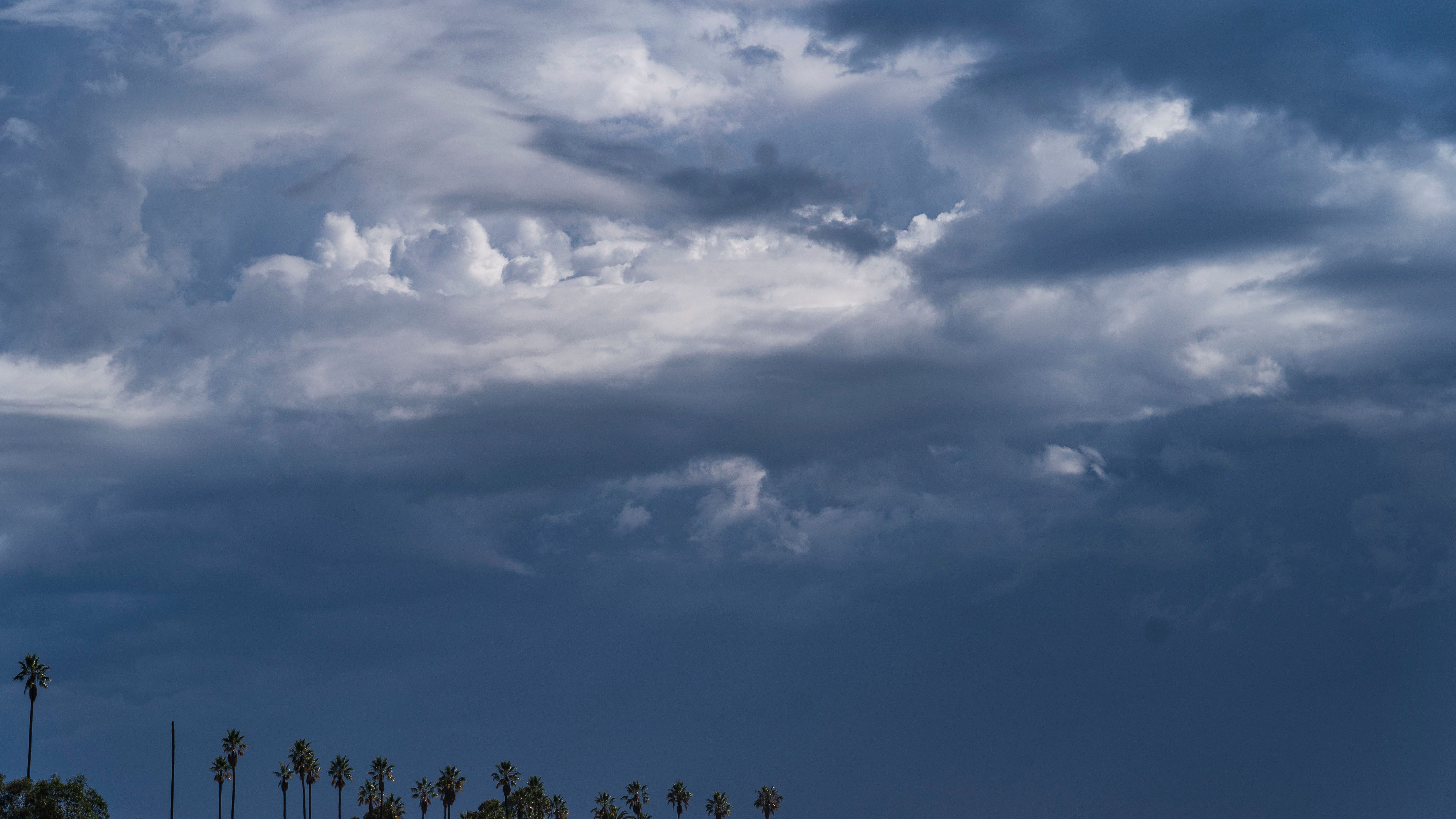 Cloud formations move over Elysian Park overlooking the San Gabriel Mountains in Los Angeles, Wednesday, June 22, 2022.